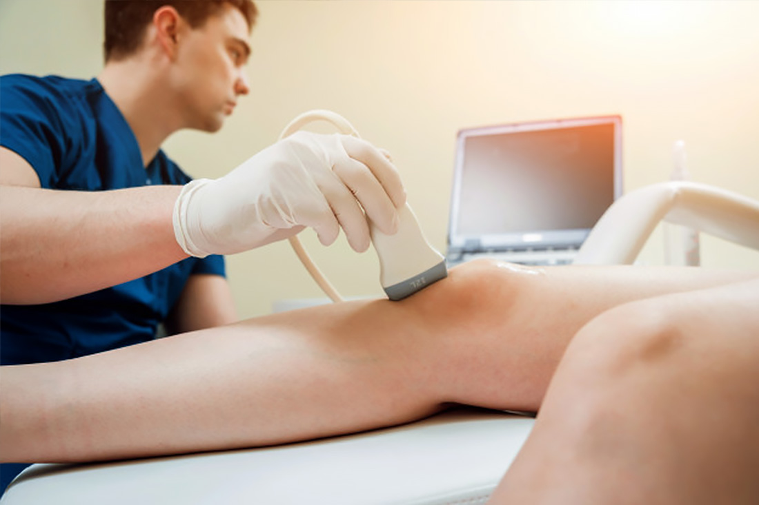 Ultrasound in Physical Therapy. Therapist Using Ultrasound Applicator on a Patient’s knee